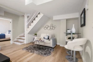 A stylish living room showcasing a staircase and a modern couch, blending comfort with contemporary design